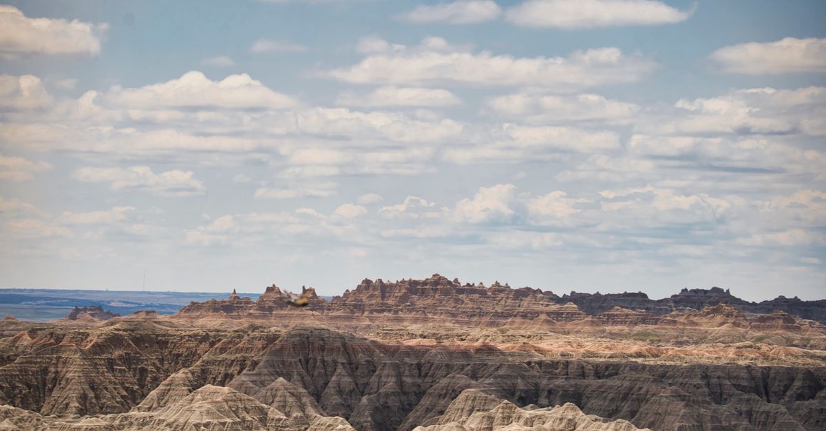 Dramatic landscape of Badlands National Park under a cloudy sky.